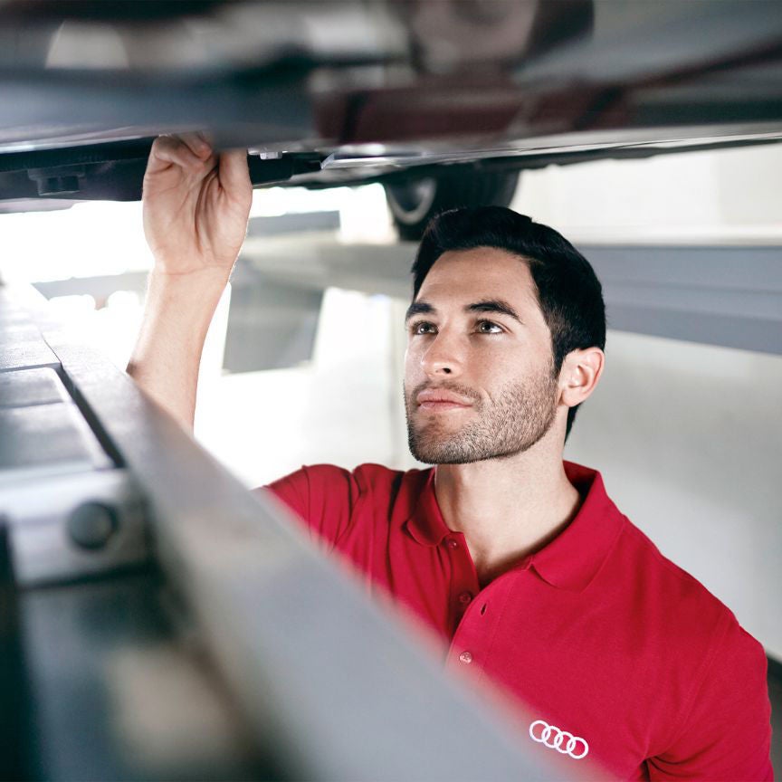 Audi Technician looking under an Audi